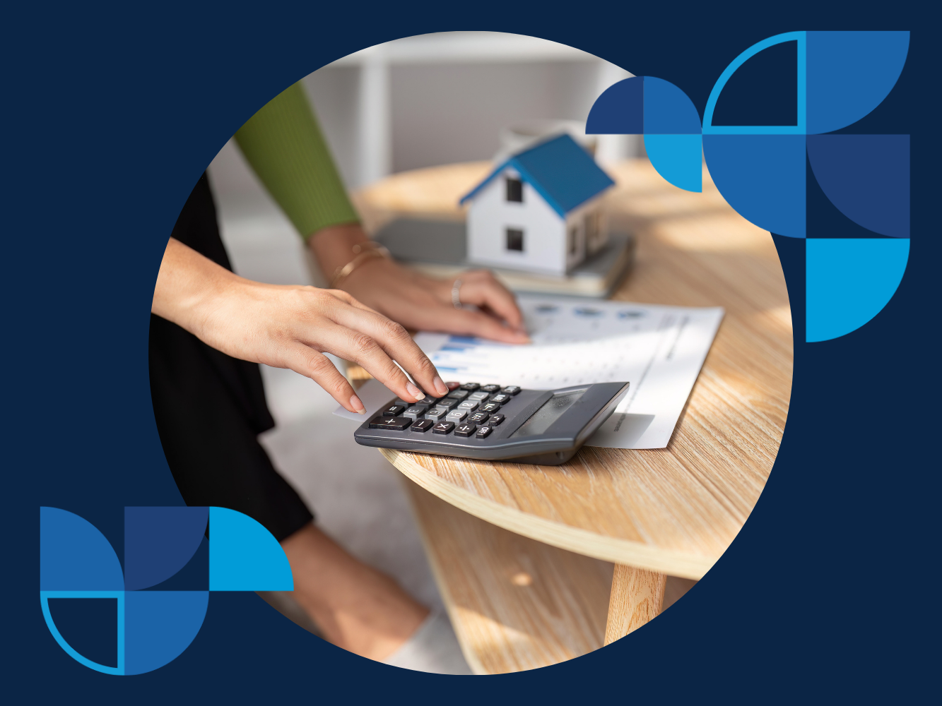 The ABCs rental income taxes A person is using a calculator on a table. There is a pen next to the calculator and papers spread out on the table.